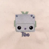 La broderie de la pochette Tibo le Robot